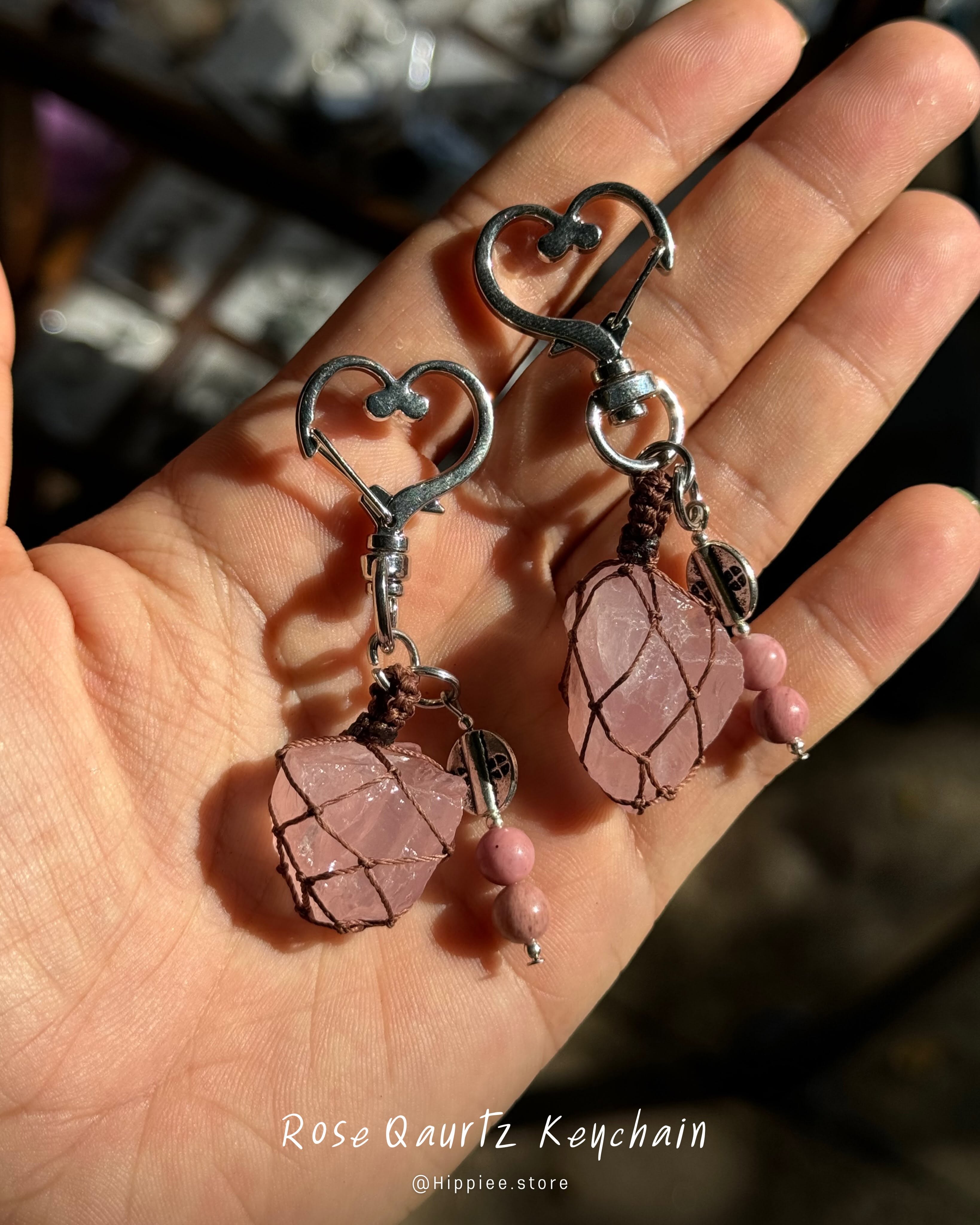 Rose quartz keychains held in a hand